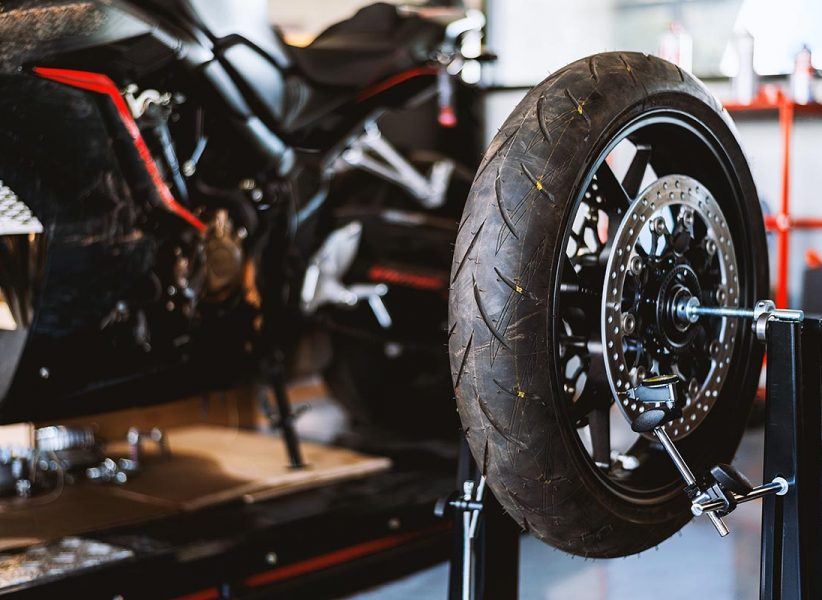 motorcycle  repair. closeup wheel balancing machine at tyre service center with soft-focus and over light in the background