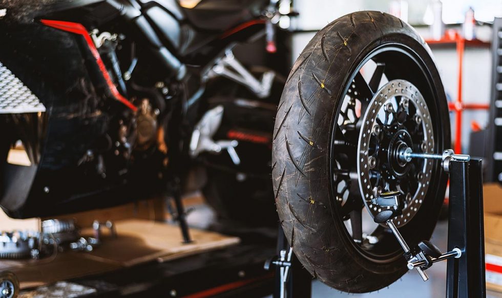 motorcycle  repair. closeup wheel balancing machine at tyre service center with soft-focus and over light in the background